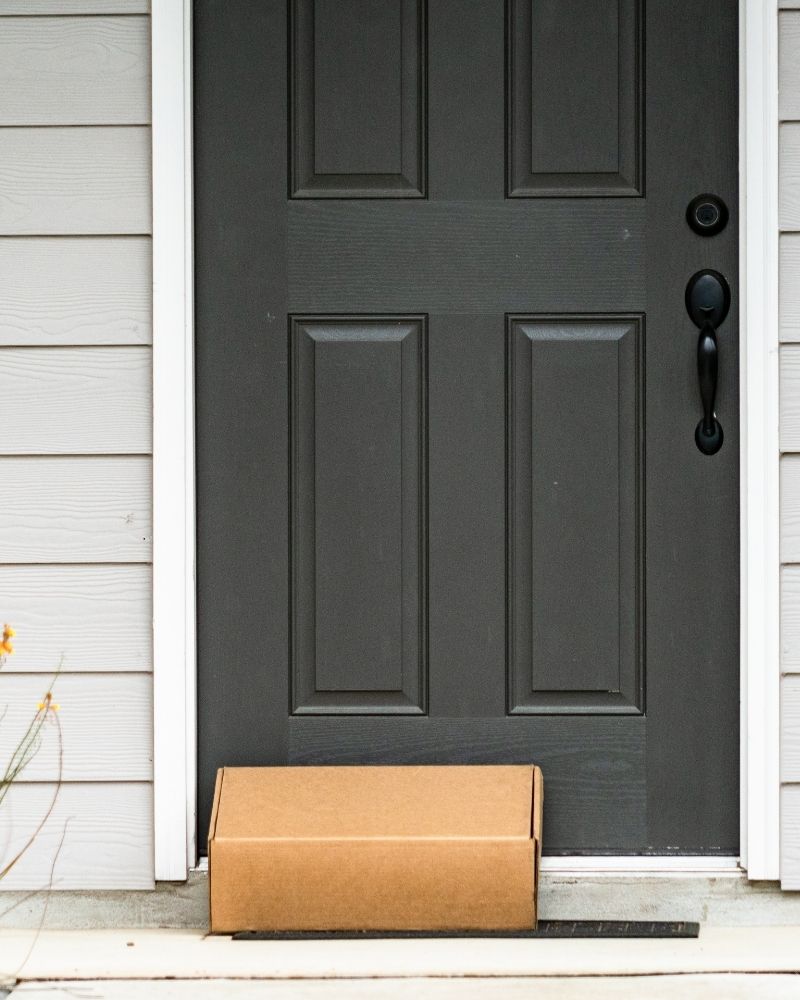 A package of clear aligners at someones door ready to be picked up.